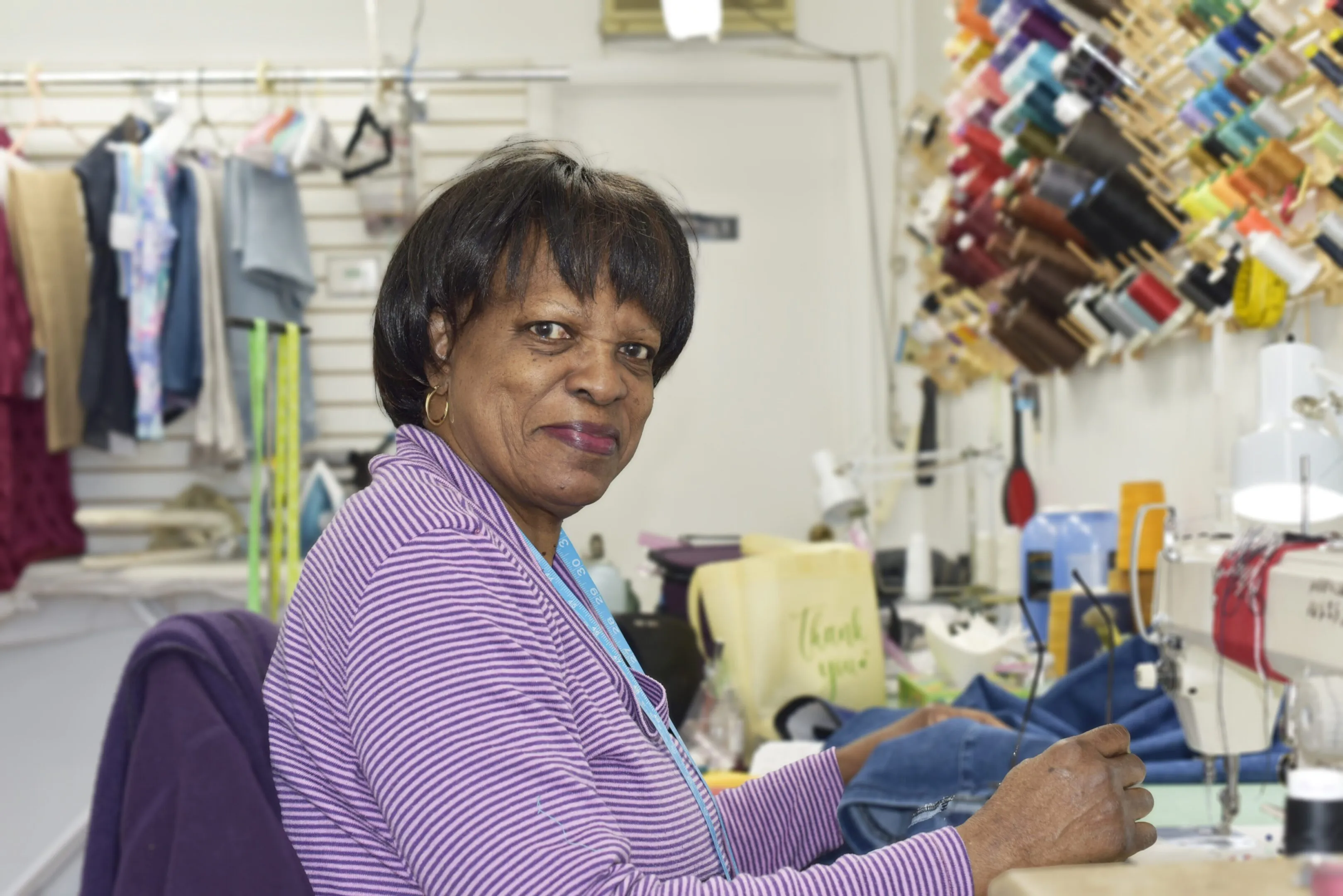 Geneve, seamstress at JM Cleaners, at work on a garment