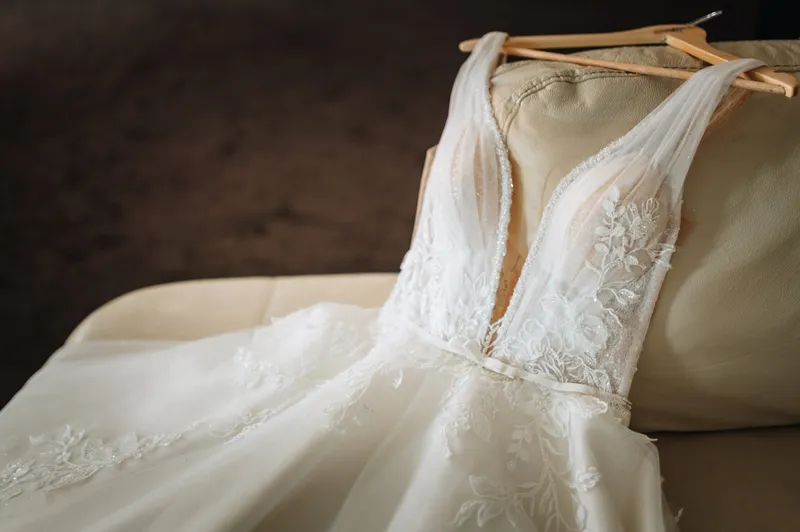 A lace wedding gown cleaned and preserved by JM Cleaners