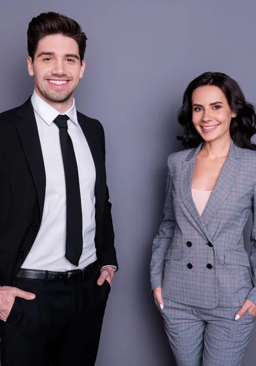 A man and woman dressed in formal suit and evening wear
