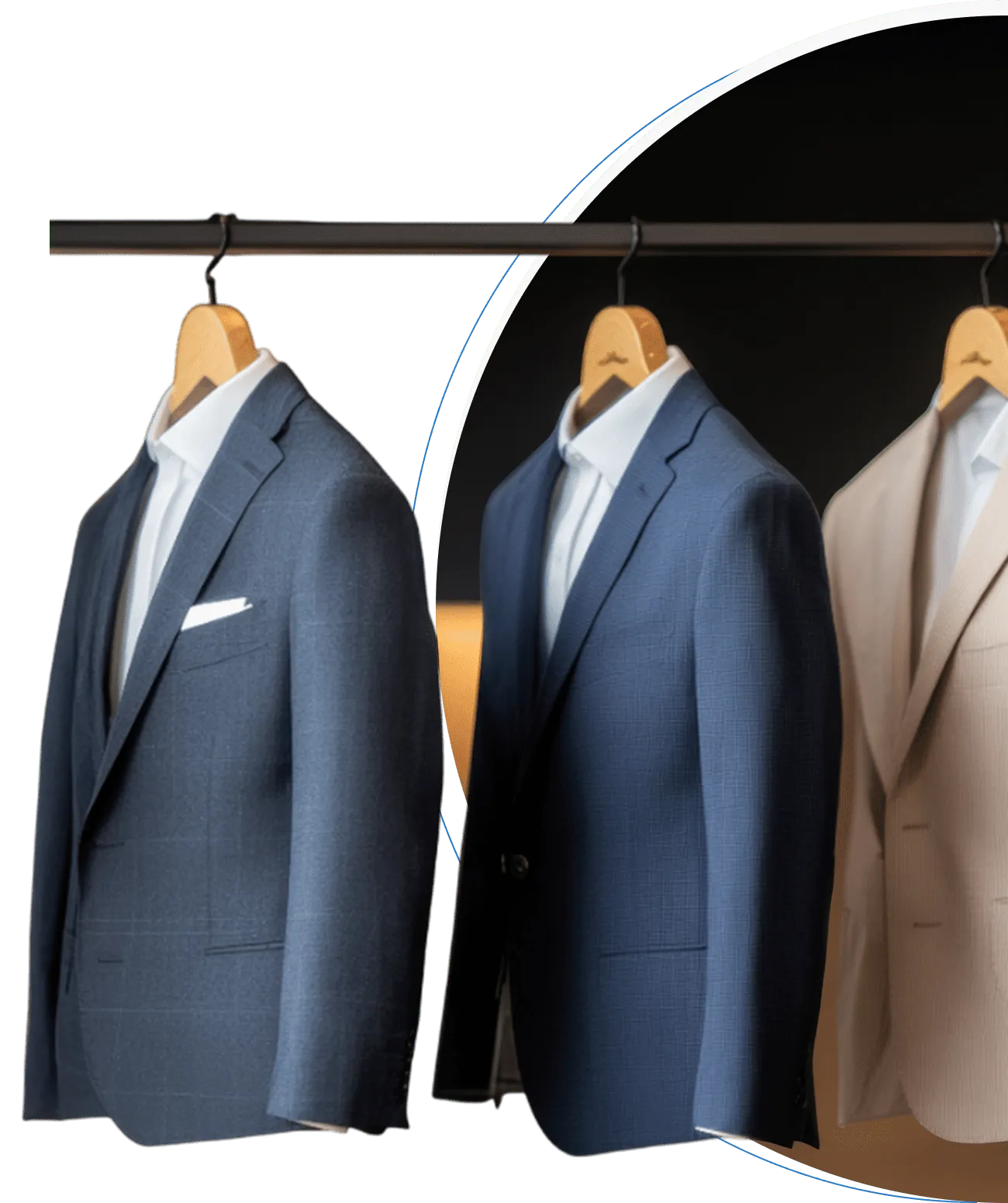 Freshly cleaned and pressed navy and beige suit jackets on wooden hangers